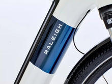Load image into Gallery viewer, Close-up of a Raleigh bicycle frame with a white and blue design.