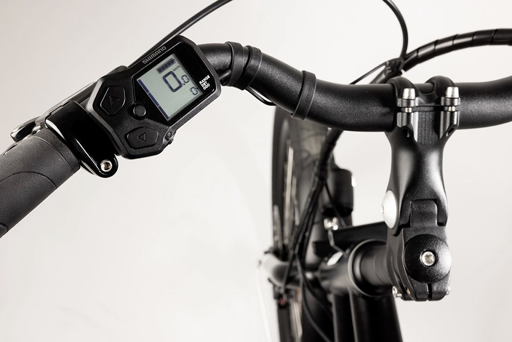 A close-up image of the Yuba Kombi E6 electric longtail cargo bike showing the electric control display on the bike's handlebars.