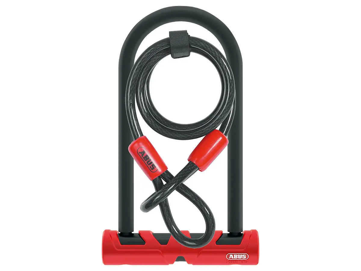 Red and black U-shaped bike lock with a cable from Abus on a white background.