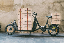 Load image into Gallery viewer, A photo showing a Yuba Supercargo electric cargo bike loaded with boxes which are strapped down with the Yuba Utility Straps.