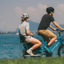 Load image into Gallery viewer, A product image of the Yuba Backrest showing two backrests mounted on two Yuba Crests, with an adult rear passenger.