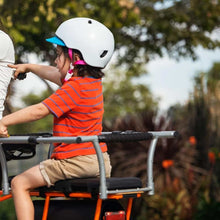 Load image into Gallery viewer, A photo of a Yuba soft spot on the back of a Yuba spicy curry cargo bike with a child passenger