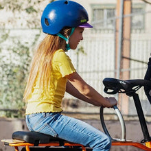 Load image into Gallery viewer, A photo of a child passenger on the back of a Yuba longtail cargo bike holding onto the Yuba Ring accessory.
