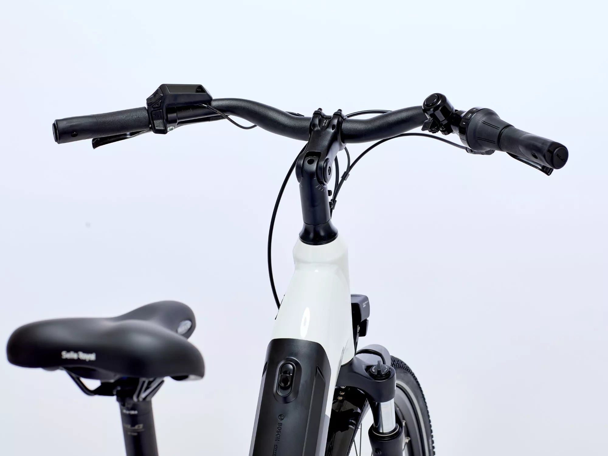 White electric bike with black handlebars and seat on a light gray background