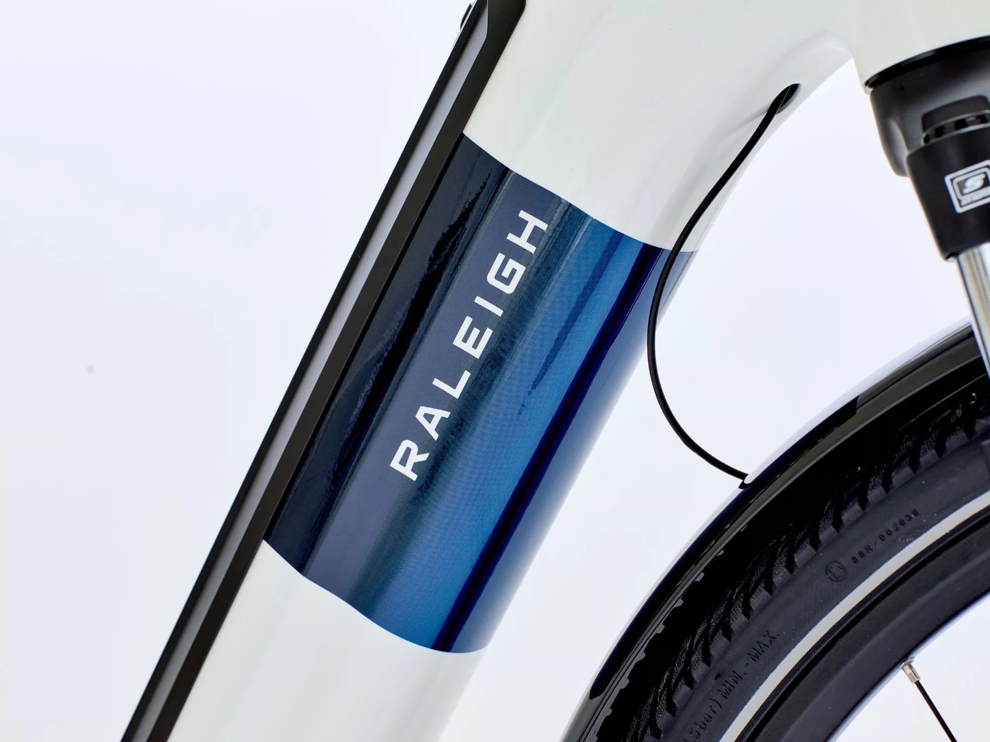 Close-up of a Raleigh e bike frame with a white and blue design.