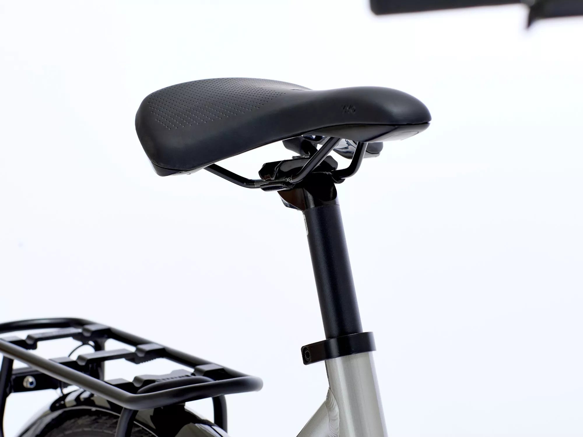 Close-up of a bicycle seat with a white background.