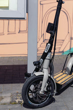 Load image into Gallery viewer, A photo of an escooter with an Abus Alarmbox 2.0 device attached. 
