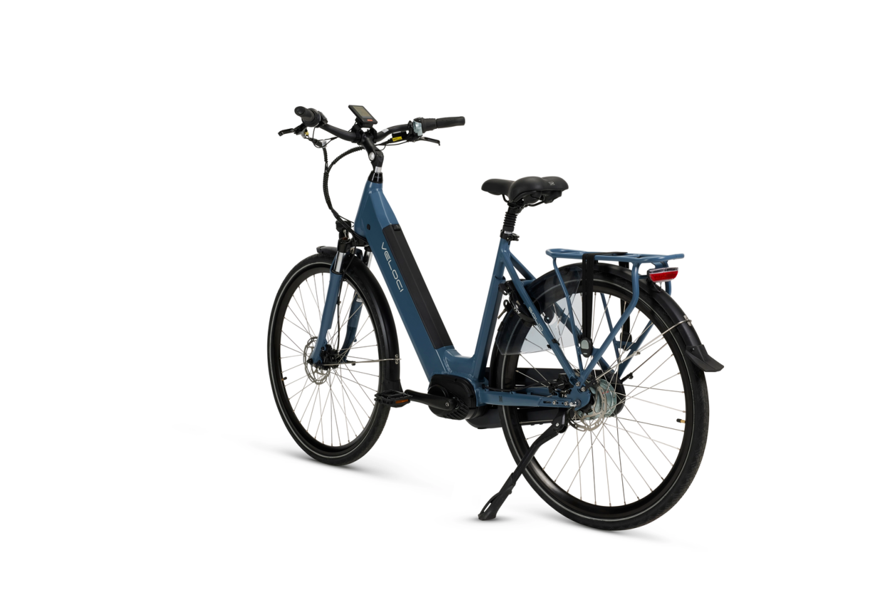 A product image of a Veloci Solid electric bike. The photo is taken at an angle against a white background, displaying all the features on the lefthand side of the electric bike. The electric bike has a dark blue frame, the colour is called "Eclipse Blue." 