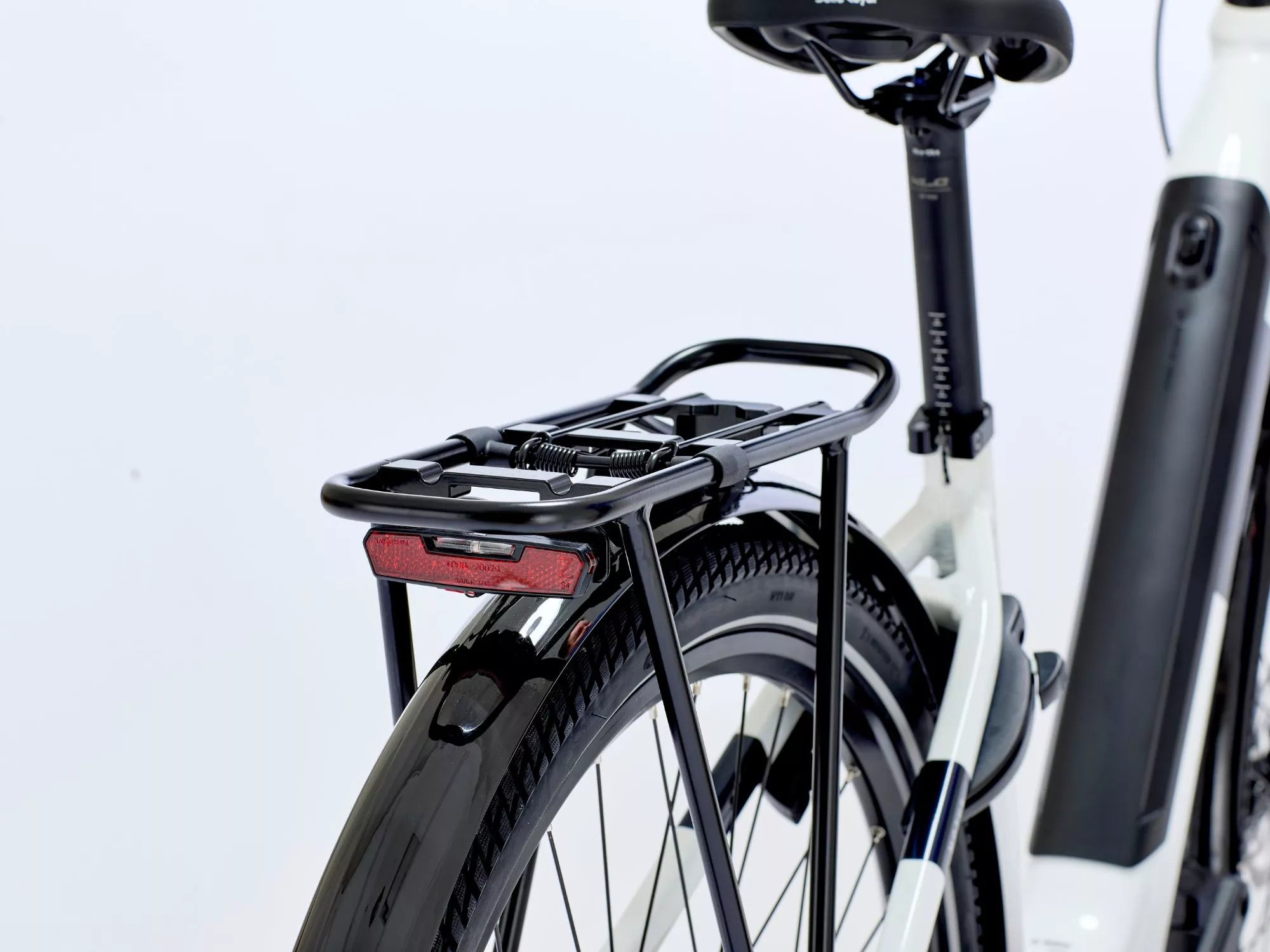 Electric bicycle with a black rear rack on a white background