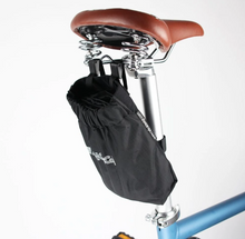 Load image into Gallery viewer, A close-up photo of the saddlebag which carries the Ahooga Transport Cover for the Ahooga folding ebike range. The saddlebag is attached to the seat post and the underside of the Ahooga bike saddle.

