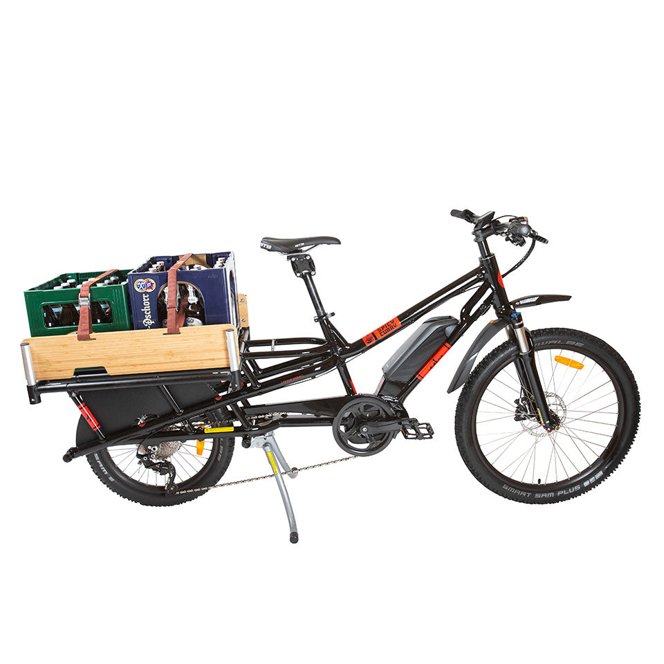 A product picture of the Yuba Carry-On platform which extends the carrying capacity of the Yuba Spicy Curry electric longtail cargo bike. Two crates of beer are strapped to the Carry-On Rack.