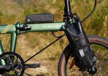 Load image into Gallery viewer, Green electric bike with black battery pack on a blurred natural background
