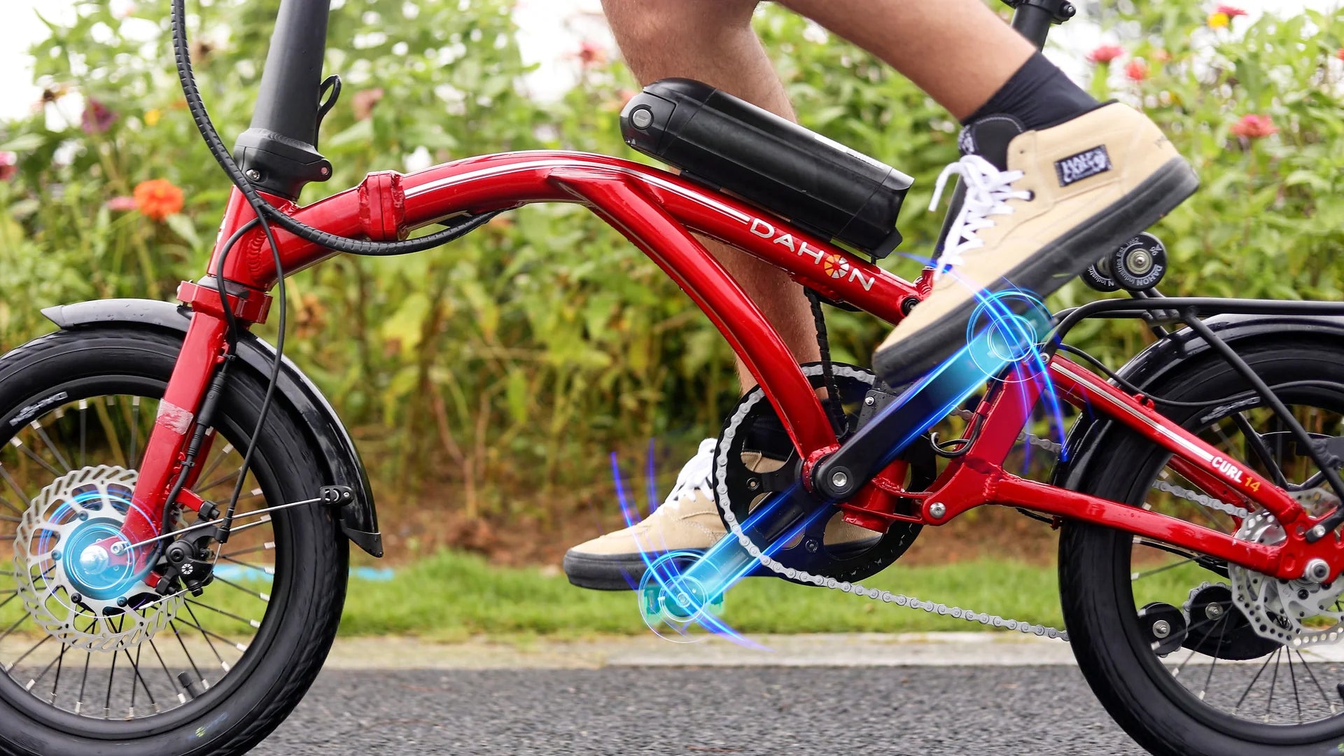 Person riding a red Dahon Curl electric bike with a blurred background