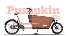 Load image into Gallery viewer, Product image of the Dolly Joy electric cargo bike with a black frame and cargo box. There is large text behind the bike describing its colour: Pumpkin Pie.
