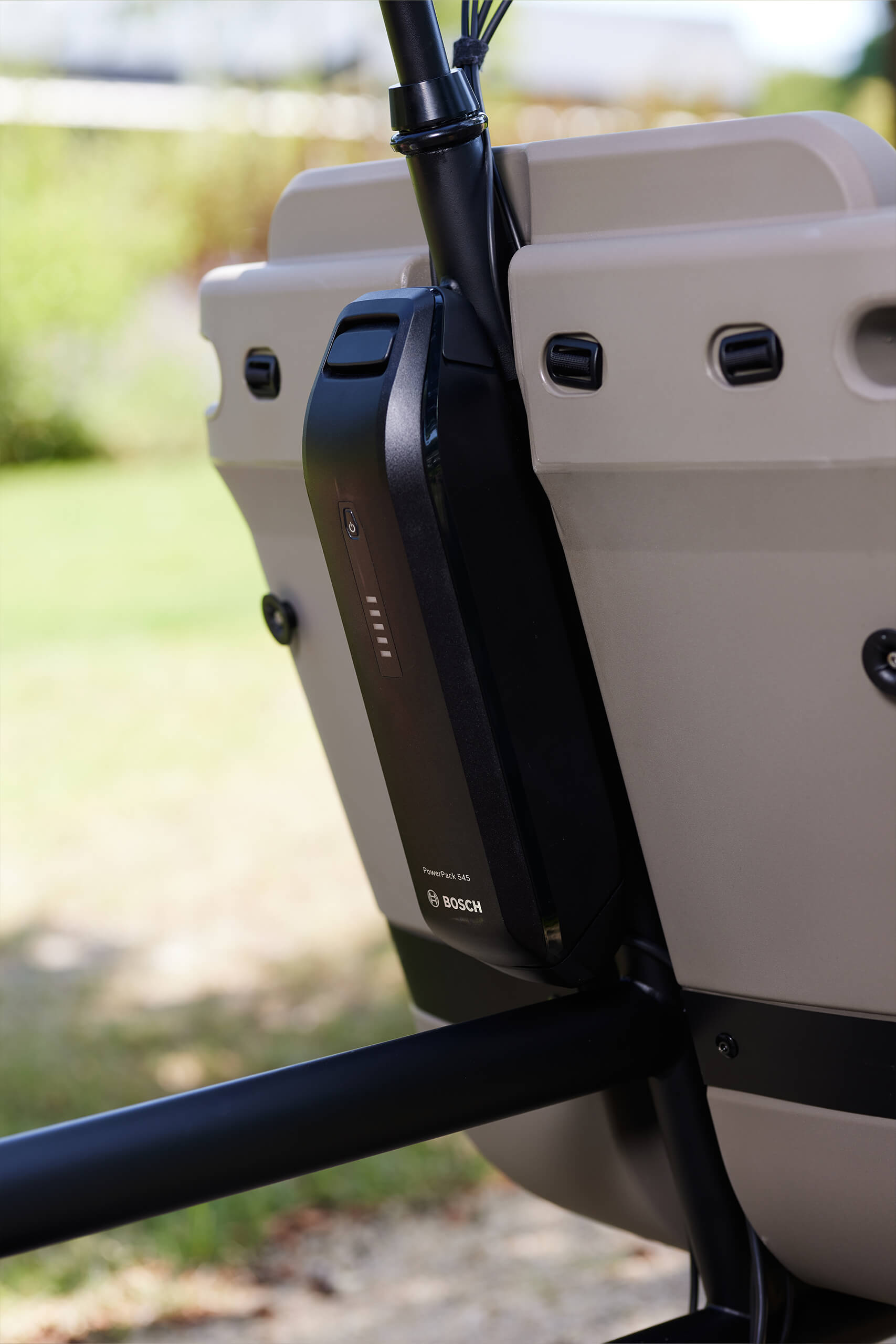 A lifestyle image showing the Bosch battery on the Dolly Joy electric cargo bike.