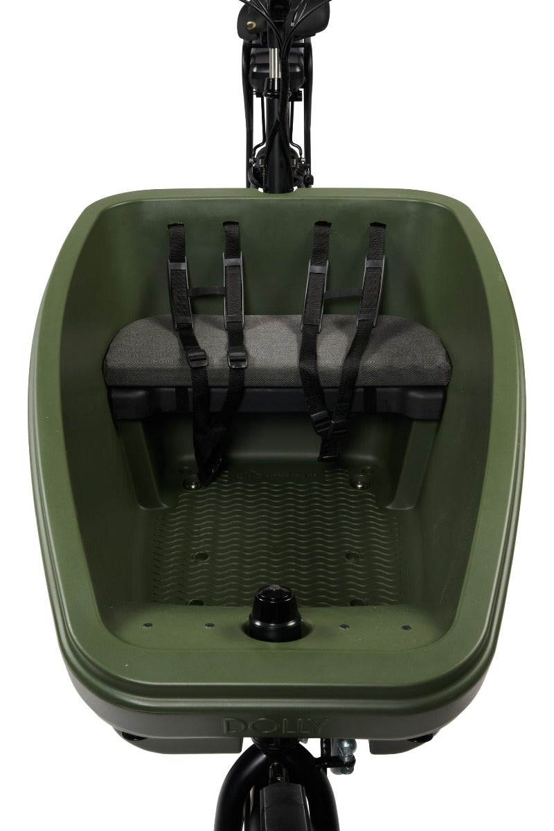 A product image showing the Dolly seat cushion fitted on the standard bench of a Dolly electric cargo bike.