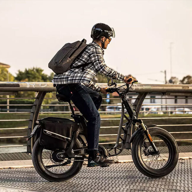 A lifestyle image of the Fantic Issimo Urban electric bike, with a man riding the bike in an urban setting.