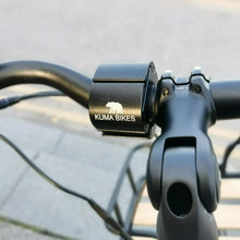 Load image into Gallery viewer, A product image of the Kuma Paw Phone Holder showing a phone in position on the handlebars of a Kuma electric bike.
