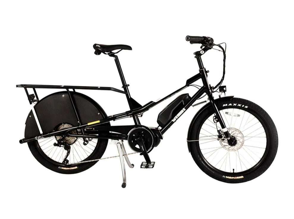 A product image of the Yuba Kombi E6 electric longtail cargo bike. This is the bare layout of the bike, with no accessories added. The bike has a black frame. 