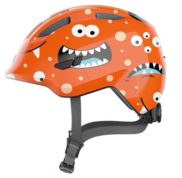 A product image of the Abus Smiley 3.0 children's bicycle helmet with the orange monster colour.