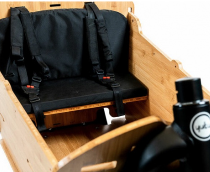 A close-up view of the seat kit for the Yuba Supercargo Bamboo Box add-on.