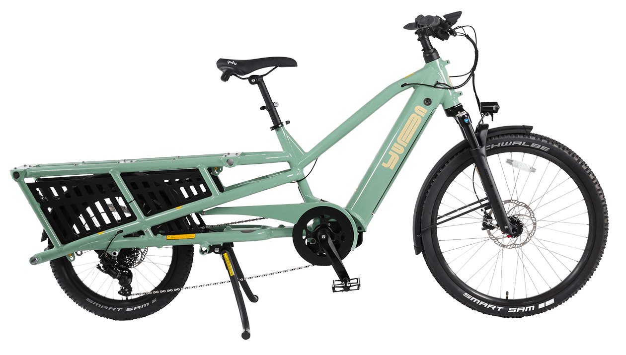 A product image of the Yuba Spicy Curry V4 electric longtail cargo bike. The frame colour is Lunar (a pale green colour) and the bike is in its basic set up, with no accessories attached. 