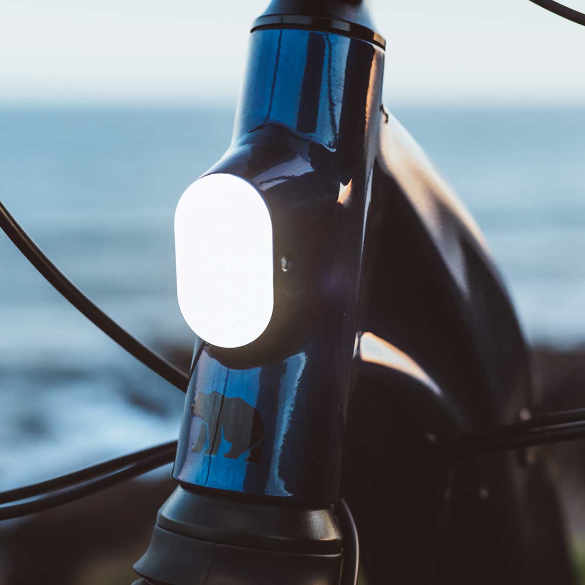 A close-up photo of the front light of a Kuma S2 electric bike.