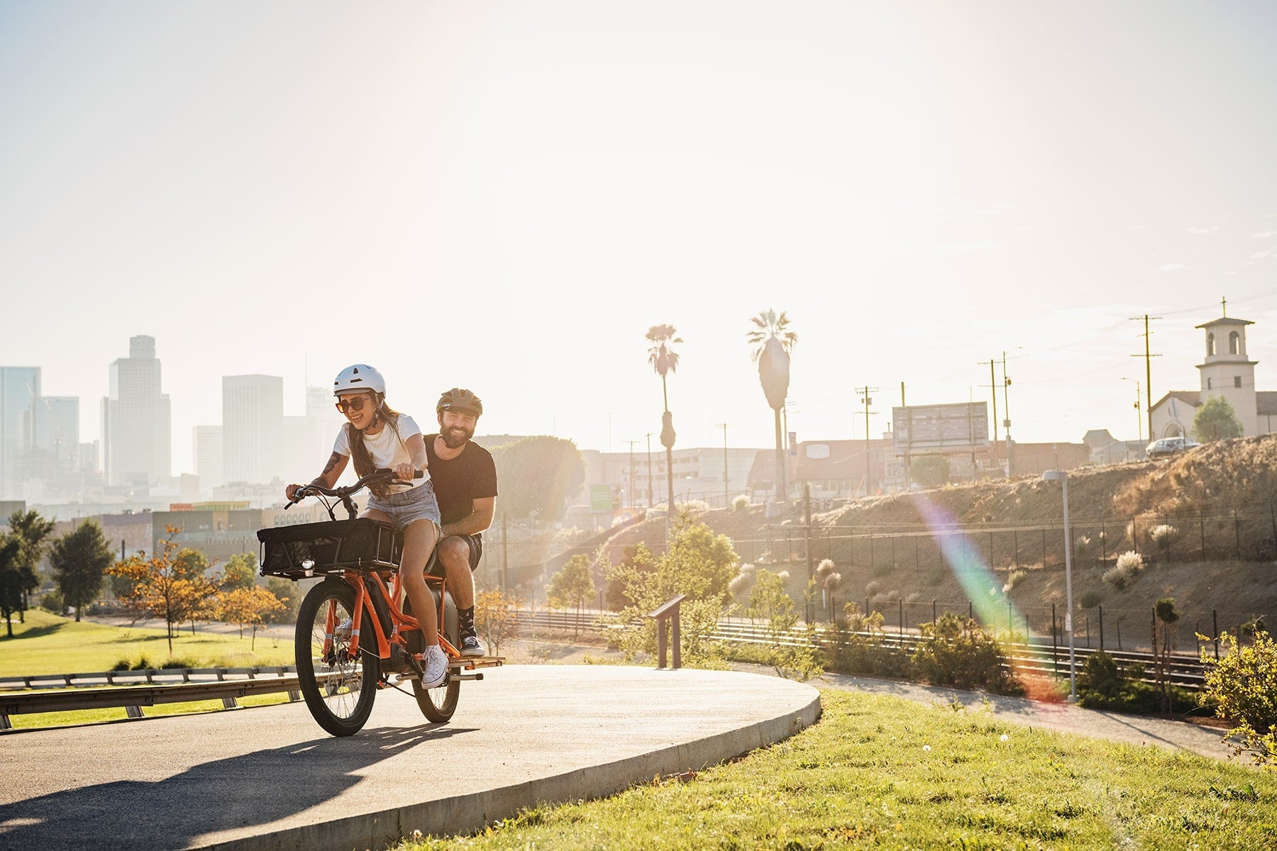 Adult carrying another adult on a cargo bike