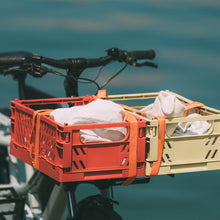 Load image into Gallery viewer, A photo of the Yuba Front Eco Deck attached to the front of a Yuba longtail cargo bike with two plastic crates strapped on top of the deck.
