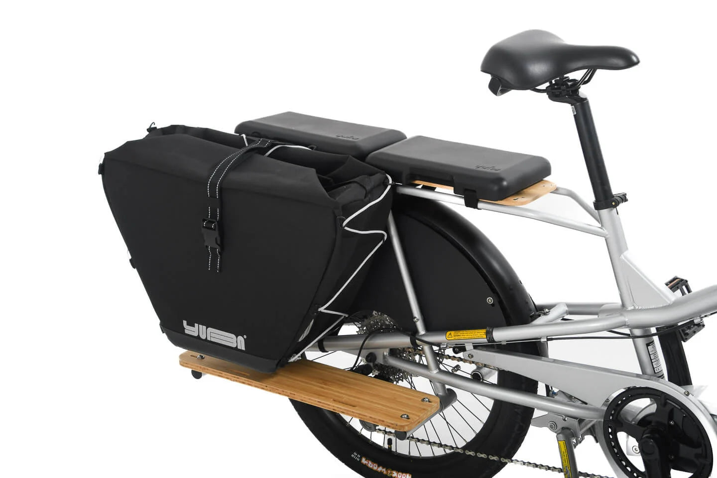 A product image showing the Yuba Eco Baguette bike bag attached to the rear rack of a Yuba Longtail cargo bike. 