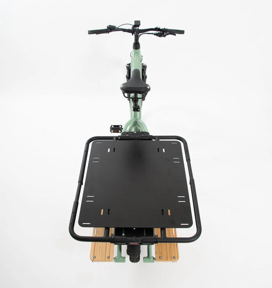 A product image showing another angle of the black Yuba Carry-All rack on the back of a Yuba Longtail electric cargo bike.