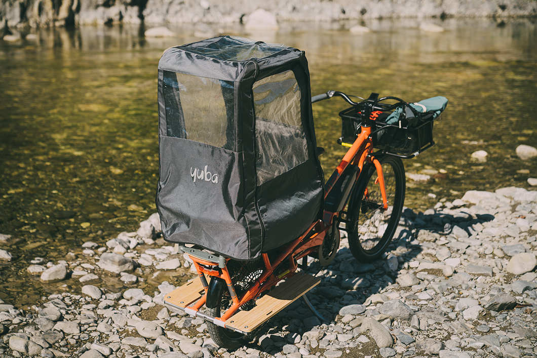 A product image of the Yuba Pop Top rain tent installed on a Yuba longtail cargo bike.