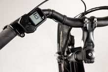Load image into Gallery viewer, A close-up image of the Yuba Kombi E6 electric longtail cargo bike showing the electric control display on the bike&#39;s handlebars.
