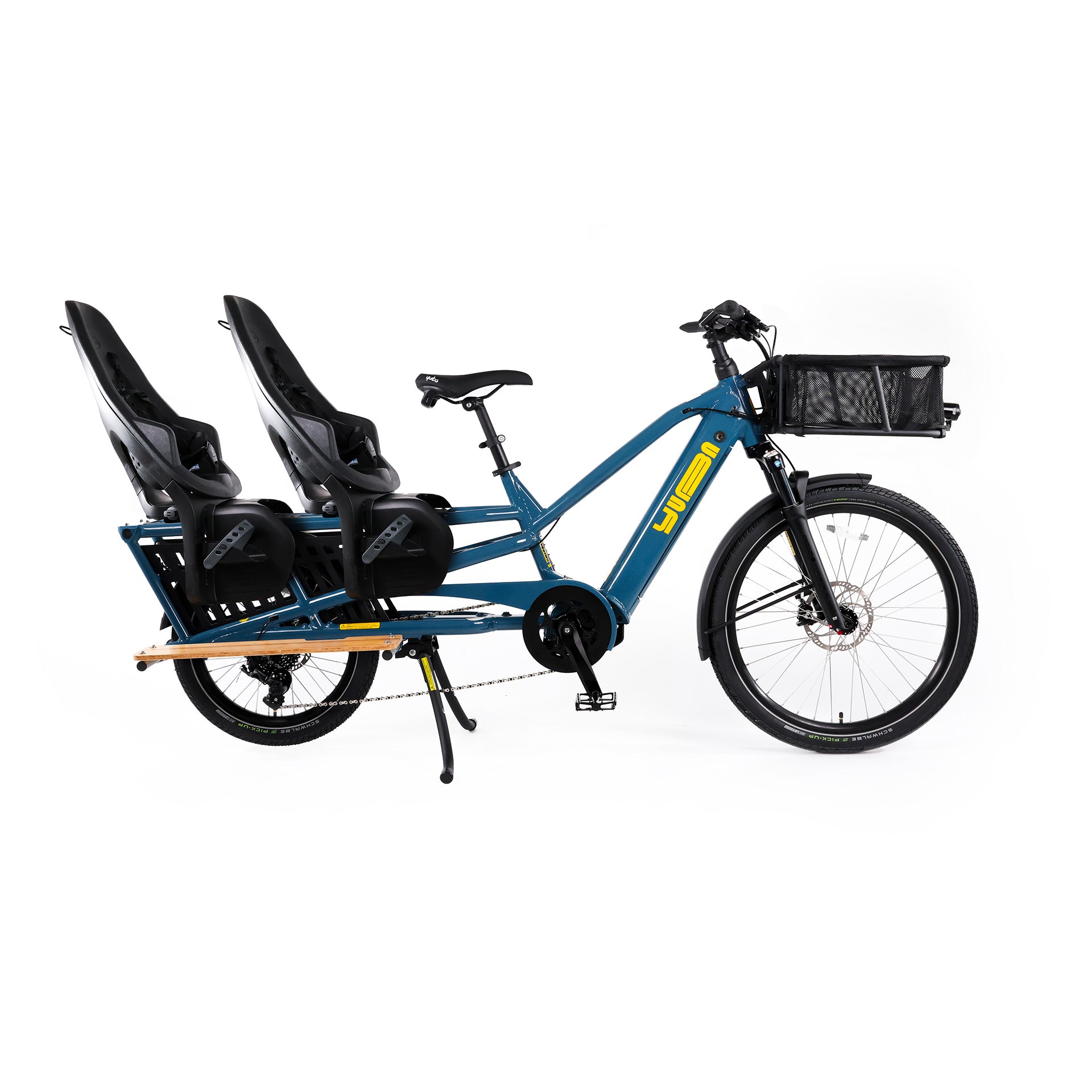 A product image of the Yuba Spicy Curry V4 electric longtail cargo bike. The frame colour is True Blue and the bike is set up with two rear child seat add-ons and a front bread basket.. 