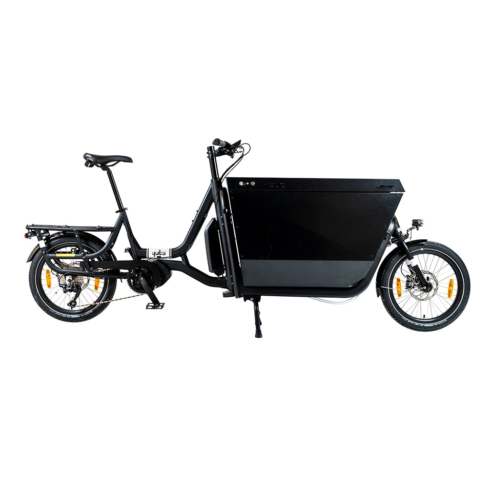 A product image of the Yuba Supercargo CL electric front-loading cargo bike. The model shown has a black frame and a specialised delivery box on the front end which can be locked. The bike is available to buy from Bleeper.