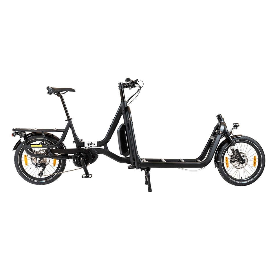 A product image of the Yuba Supercargo CL electric front-loading cargo bike. The model shown has a black frame and a basic configuration with you accessories. The bike is available to buy from Bleeper.