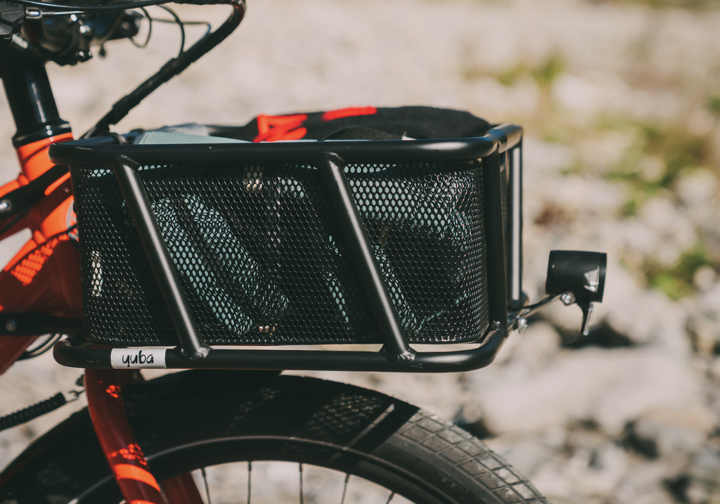 A photo of a Yuba Stuff Rack front basket attached to a Yuba longtail cargo bike.