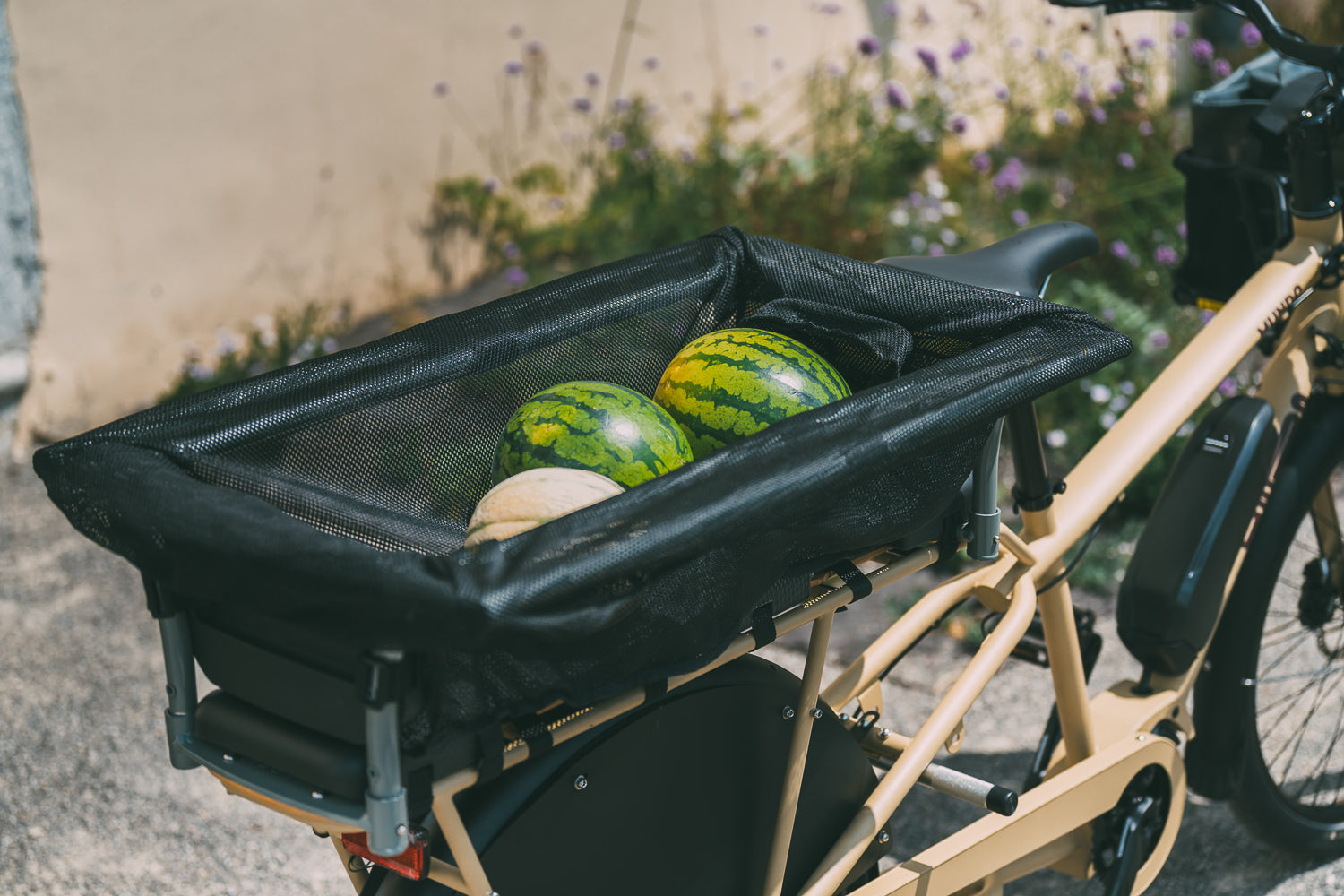 A product image of the Yuba Monkey Bars Tote accessory while carrying groceries.