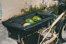 Load image into Gallery viewer, A product image of the Yuba Monkey Bars Tote accessory while carrying groceries.
