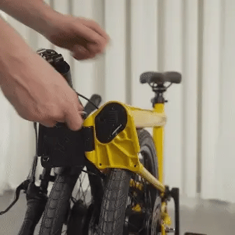 An animated gif showing the process for removing the integrated battery from the frame of the Ahooga Max folding electric bike. The battery sits inside the frame of the bike and can be fully removed to be charge. The battery can also be charged while it is still inside the frame of the bike.