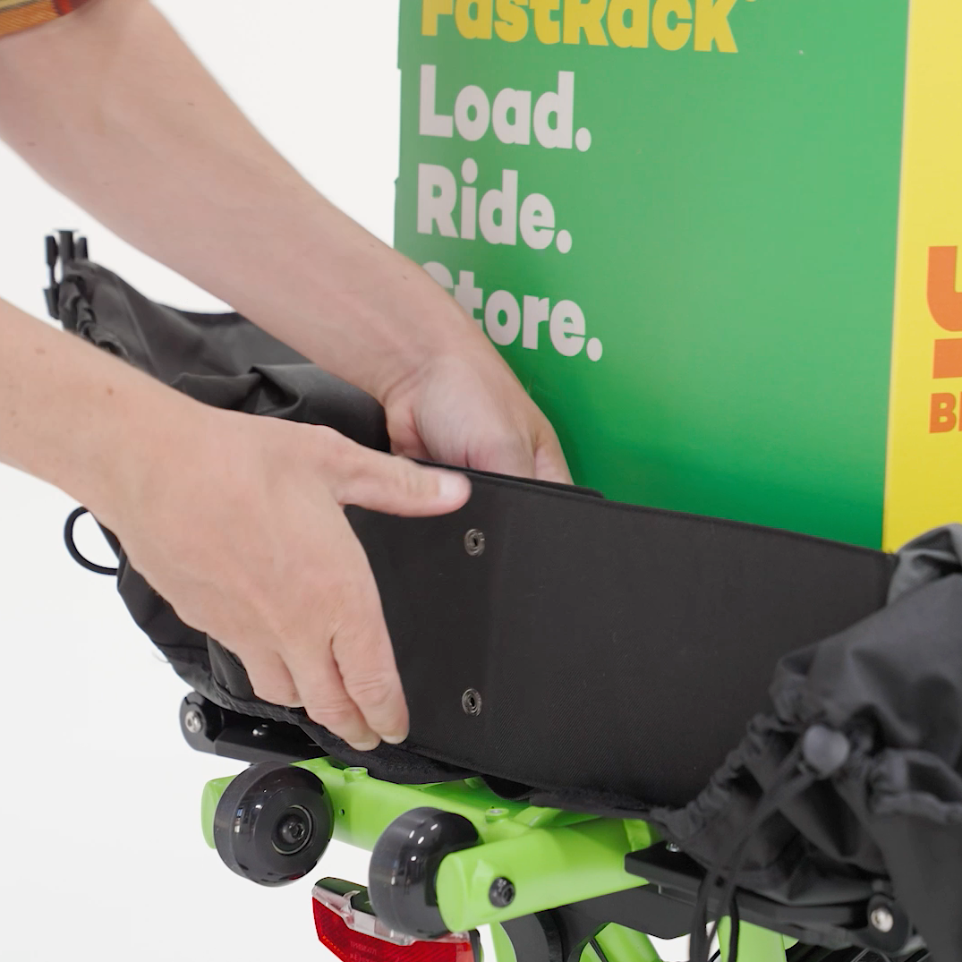 A product picture of the Yuba DRS Bags attached to the rear carrier of the Yuba Fastrack electric longtail cargo bike. This photo shows the bags being used in the a cargo bike type capacity.